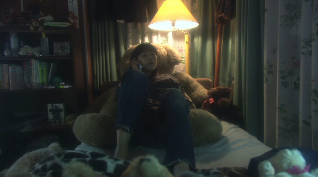 An intimate interior scene in All About Lily Chou-Chou (2001) showcases Shunji Iwai's dreamlike cinematography.
