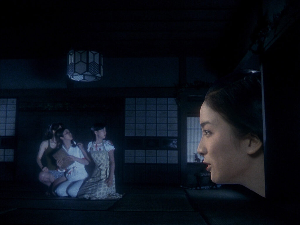 A girl watches a ghostly figure in a traditional Japanese room in House (1977).