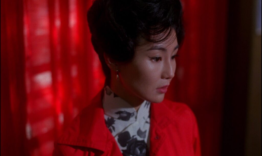 Maggie Cheung's elegant presence in In the Mood for Love (2000) reflects Wong Kar-wai's iconic visual style.