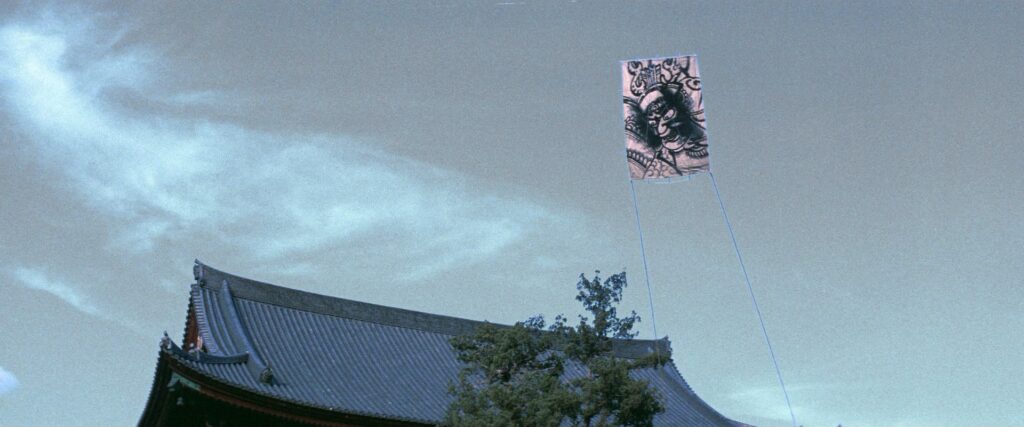 A ceremonial banner flies above a traditional temple roof in Kwaidan (1964).