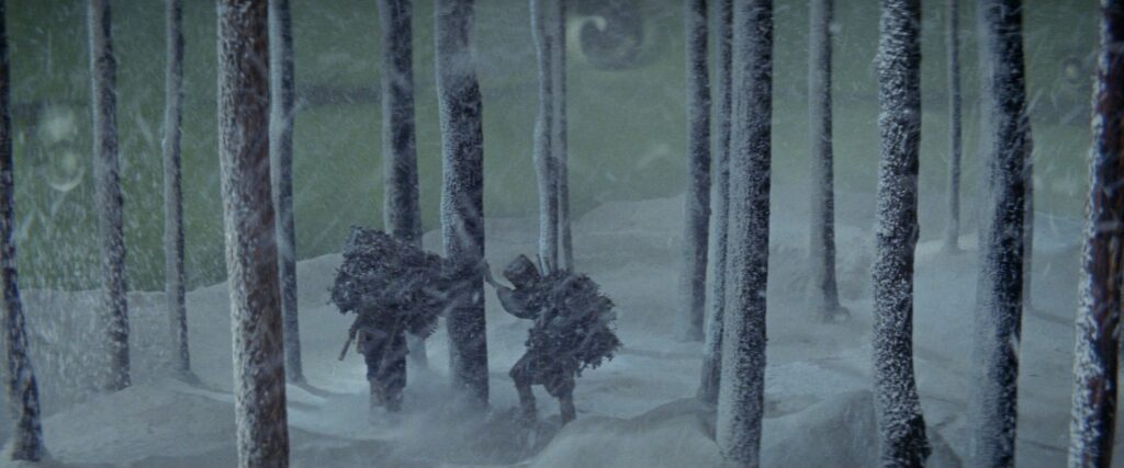 Mounted riders travel through a snowy forest in Kwaidan (1964).