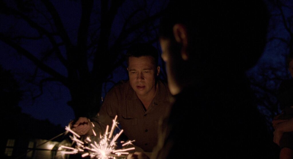 Children play with sparklers at night in The Tree of Life (2011).