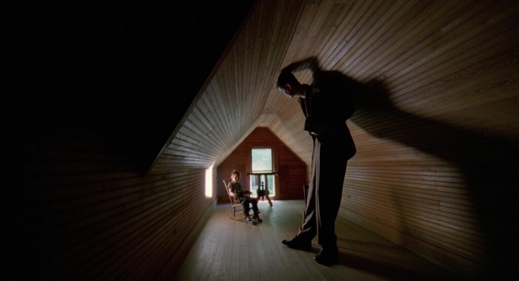 A father looms over his children in a narrow hallway in The Tree of Life (2011).
