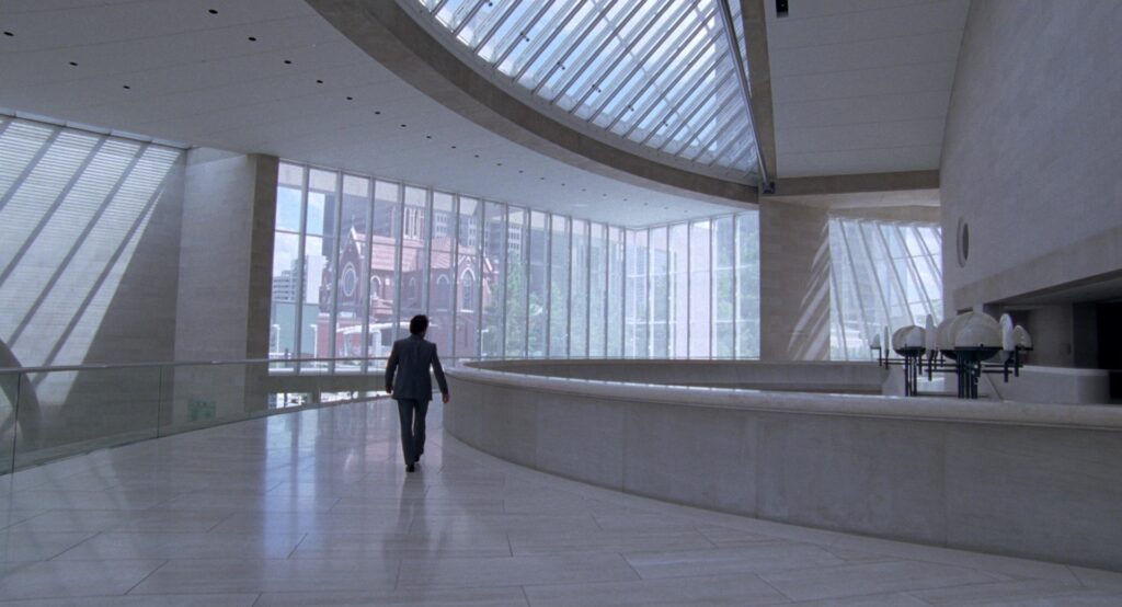 A solitary figure walks through a modern architectural space in The Tree of Life (2011).