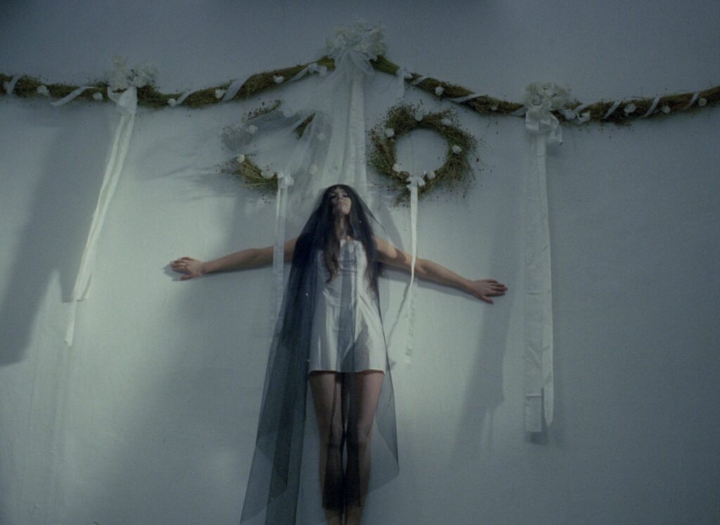 A young woman stands beneath a bridal veil in Valerie and Her Week of Wonders (1970).
