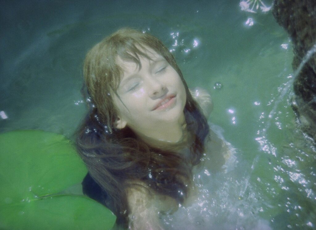Valerie floats in a pond surrounded by lily pads in Valerie and Her Week of Wonders (1970).