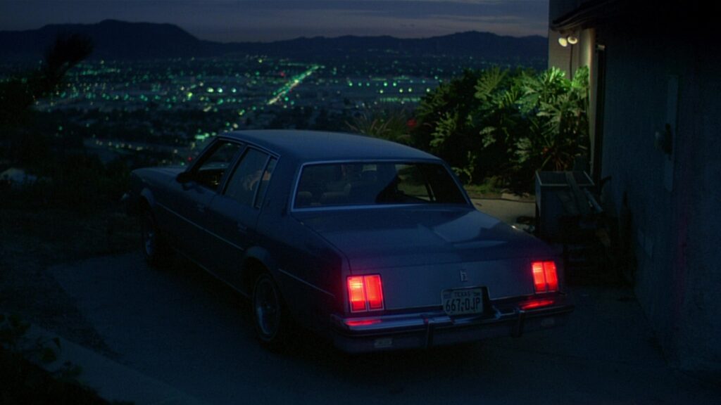 The nighttime cityscape in Paris, Texas (1984) evokes themes of distance, memory, and longing.