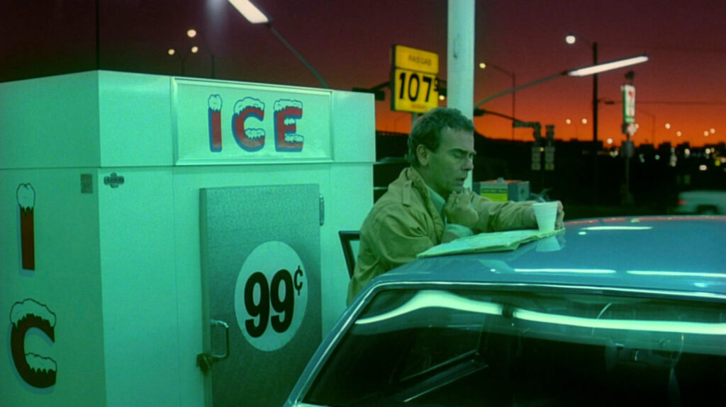 A neon-lit gas station scene in Paris, Texas (1984) showcases Robby Müller's iconic cinematography.