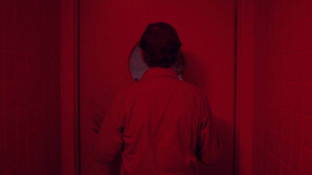 A vivid red interior in Paris, Texas (1984) showcases Wim Wenders' iconic visual storytelling.