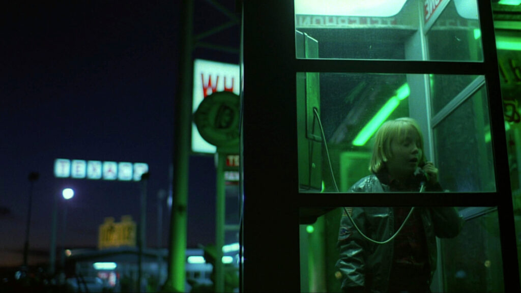 Hunter makes a phone call from a neon-lit booth in Paris, Texas (1984).