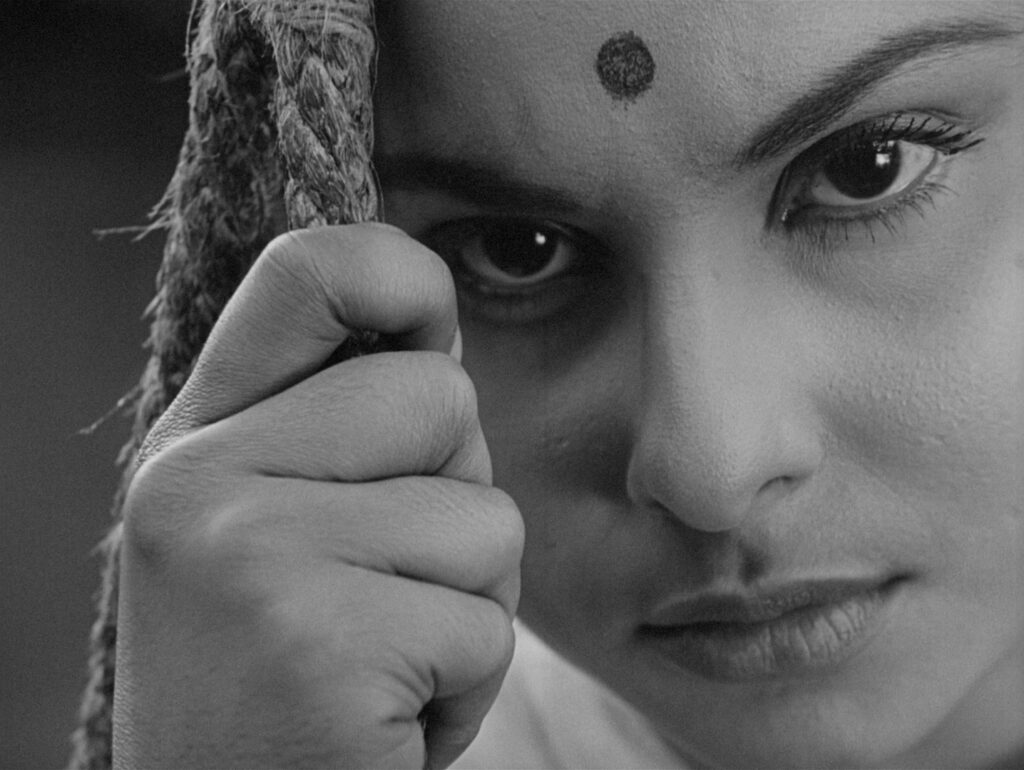 A tender close-up of Charulata during the unforgettable garden swing scene in Charulata (1964)