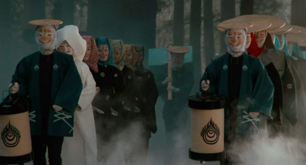A masked wedding procession walks through a misty forest in Dreams (1990).