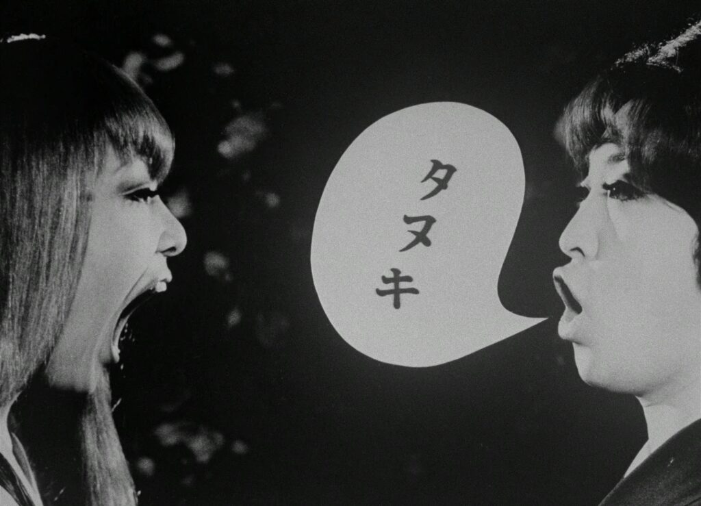 Two women face each other with a speech bubble between them in Funeral Parade of Roses (1969).