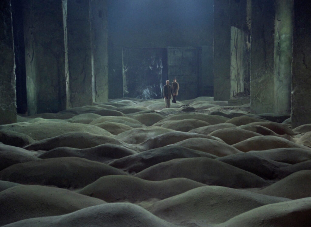The Stalker and Writer approach the mysterious Room filled with sand in Stalker (1979)