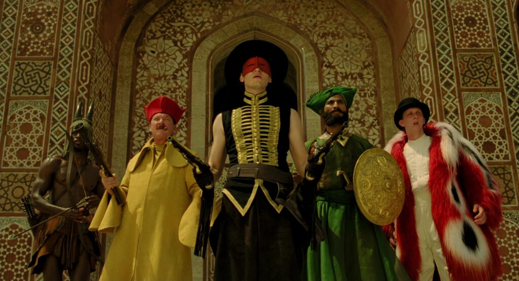 The Fall (2006) still — the five fantasy heroes at an ornate fort archway, shot on location in India