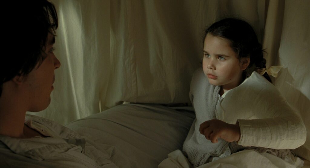 Catinca Untaru and Lee Pace in The Fall (2006), the hospital bedside scenes that anchor the film's emotional core
