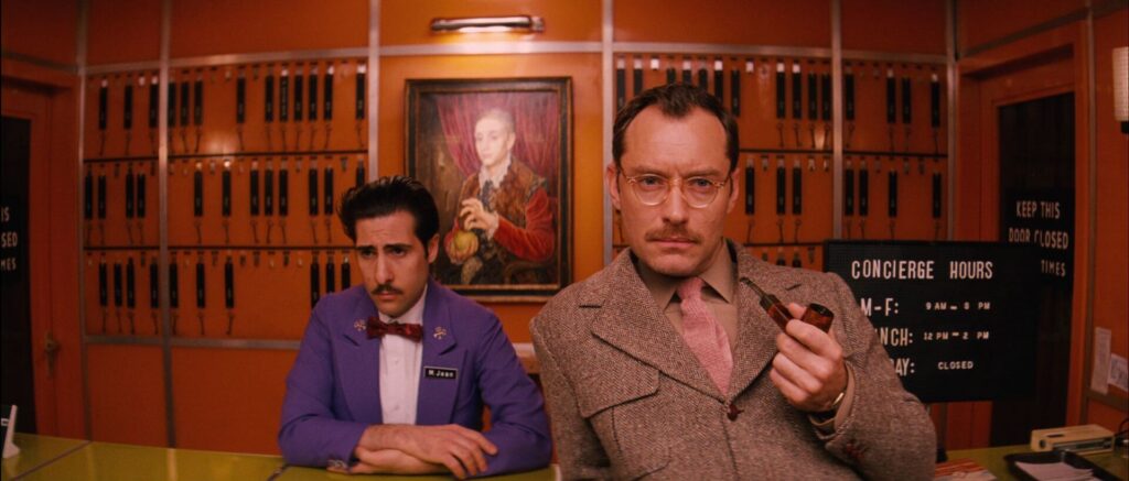 The Grand Budapest Hotel (2014) narrator Jude Law at the concierge desk with M. Jean