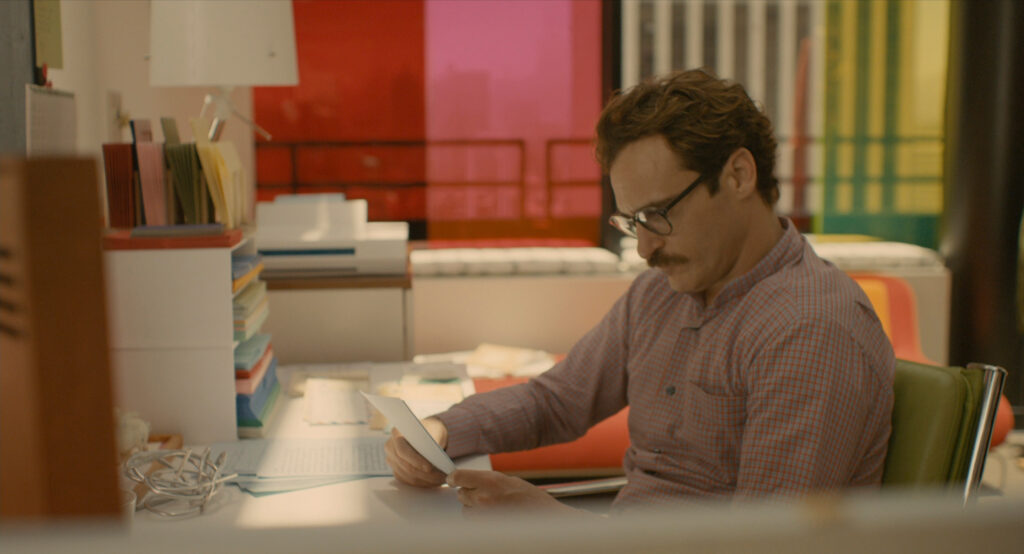 Theodore Twombly writing a heartfelt letter at his desk in Her (2013)