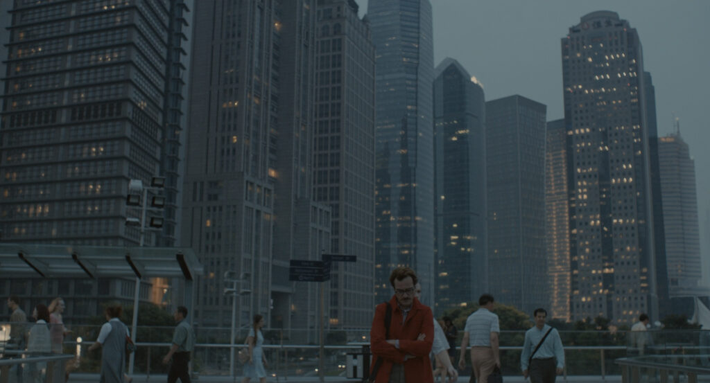 Theodore walking alone through a futuristic Los Angeles skyline in Her (2013)
