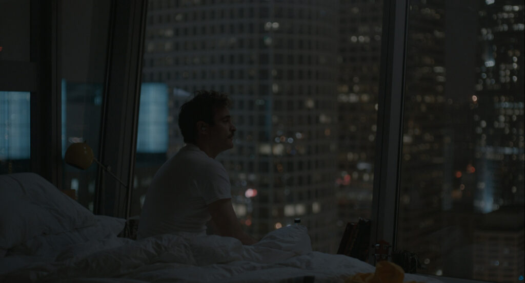 Theodore sitting alone in bed at night in Her (2013)