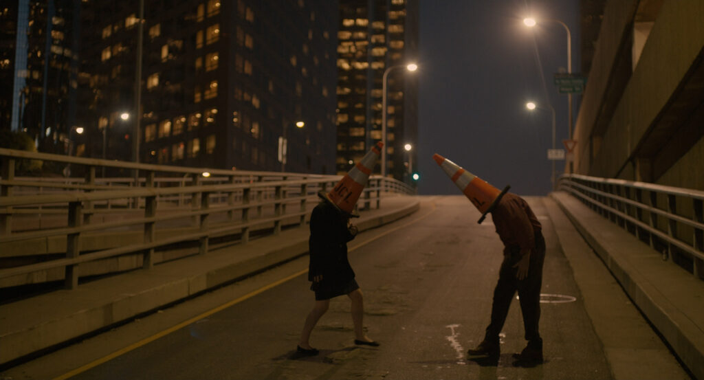 Theodore and a friend wearing traffic cone hats on an empty overpass at night in Her (2013)